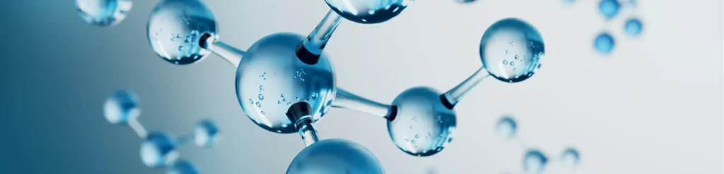 Molecole di acqua blu tridimensionali con bolle al loro interno, collegate da legami chimici su sfondo sfocato chiaro.